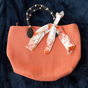 Elegant Orange Tote with Floral Scarf Accent